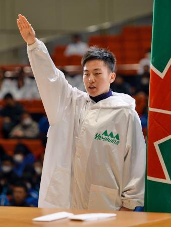 　第６４回全国高校スケート、アイスホッケー選手権の開会式で選手宣誓する山形中央の黒岩一聖主将＝２１日、山形市民会館