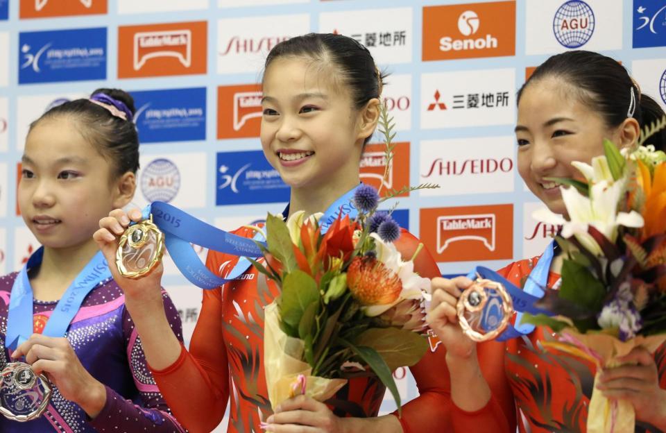 個人総合で優勝しメダルを手に笑顔の杉原愛子（中）と２位の寺本明日香（右）