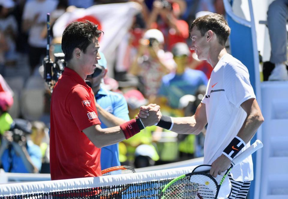 　男子シングルス１回戦でフルセットの末、アンドレイ・クズネツォフ（右）を下した錦織圭＝メルボルン（共同）