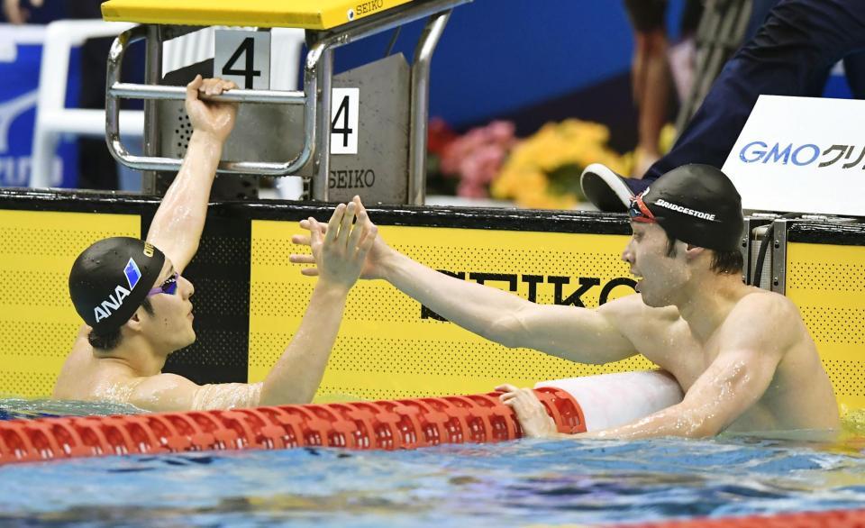 　男子２００メートル個人メドレー決勝のレース後、健闘をたたえ合う優勝した萩野公介（右）と２位の瀬戸大也＝ガイシプラザ
