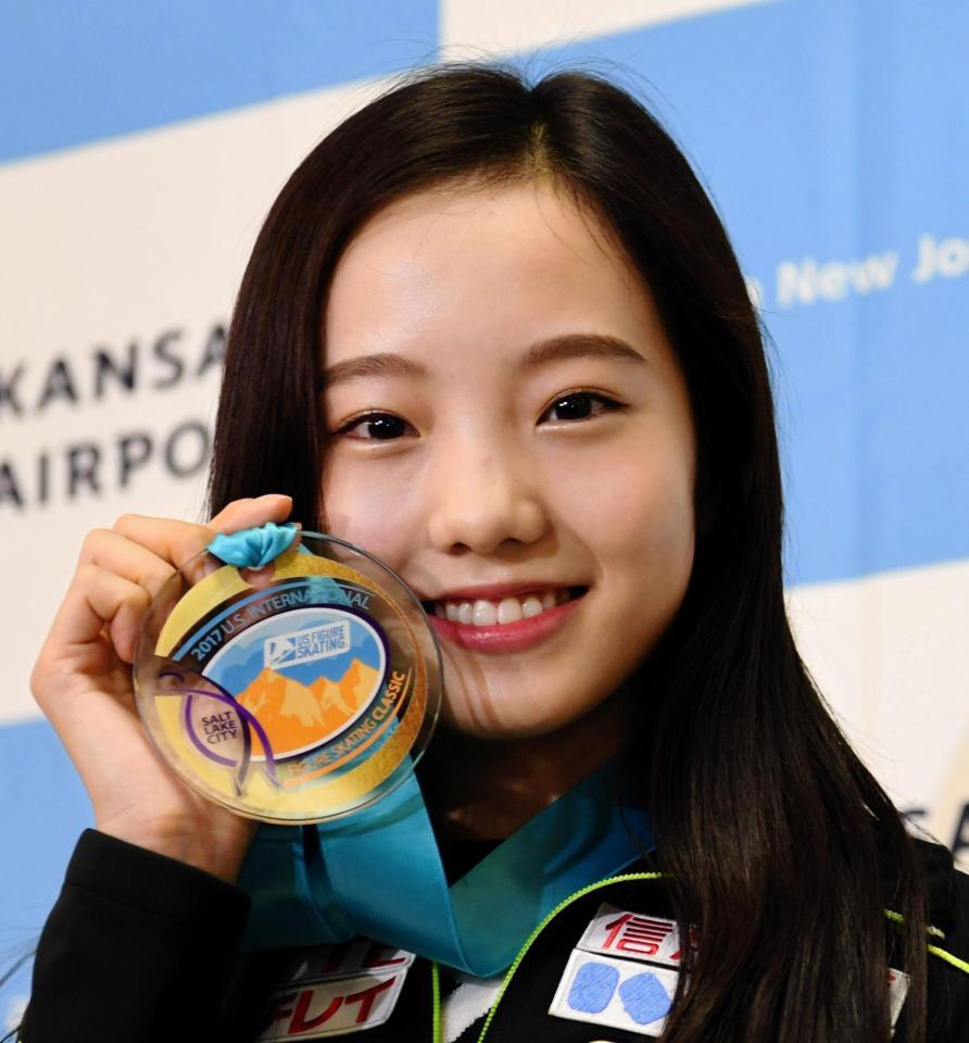 金メダルを手に笑顔を見せる本田真凜＝大阪国際空港（撮影・佐藤厚）