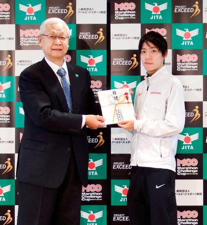 　男子マラソンの日本新記録を樹立し、報奨金の目録を受け取る設楽悠太（右）