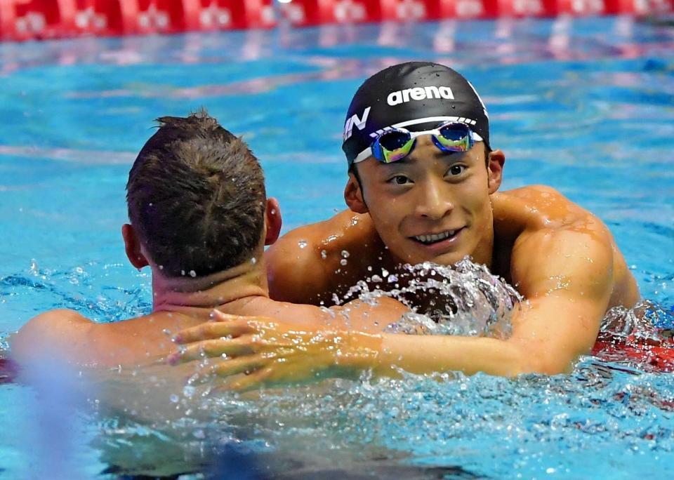 　男子１００ｍ背泳ぎ決勝を終えて健闘をたたえ合う入江陵介