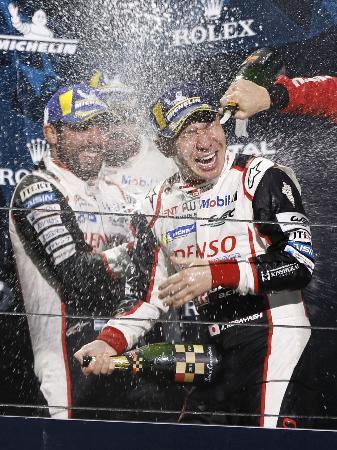 　世界耐久選手権第４戦で優勝し、シャンパンをかけ合い喜ぶトヨタ７号車の小林可夢偉（右）ら＝富士スピードウェイ