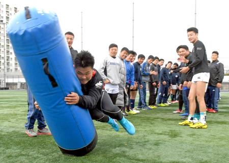 　順々にタックルし気合を入れる大阪桐蔭フィフティーン（撮影・山口登）