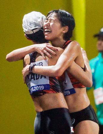 　女子２０キロ競歩　ゴール後に６位の岡田久美子（左）と抱き合う７位の藤井菜々子＝ドーハ（共同）