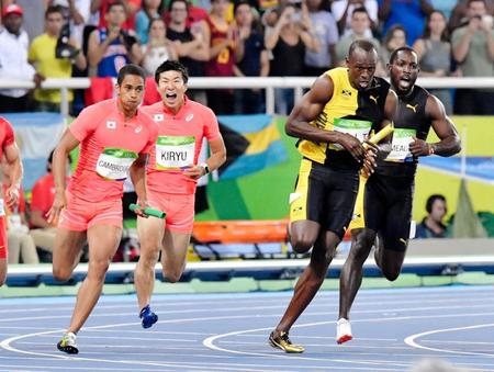 　リオデジャネイロ五輪陸上男子４００メートルリレー決勝で、第３走者の桐生祥秀からバトンを受けて走りだすアンカー、ケンブリッジ飛鳥（左端）。右から２人目はウサイン・ボルト氏（共同）