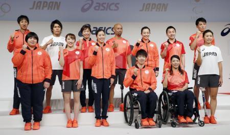 　東京五輪・パラリンピックで日本選手団が着用する公式スポーツウエアが発表され、ポーズをとる選手ら＝２１日午後、東京都中央区