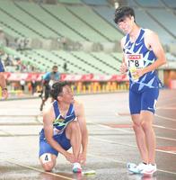 ２５日、レース後、靴ひもを結びなおしながら多田修平（右）と笑顔で言葉を交わす山県亮太＝ヤンマースタジアム長居（撮影・高部洋祐）