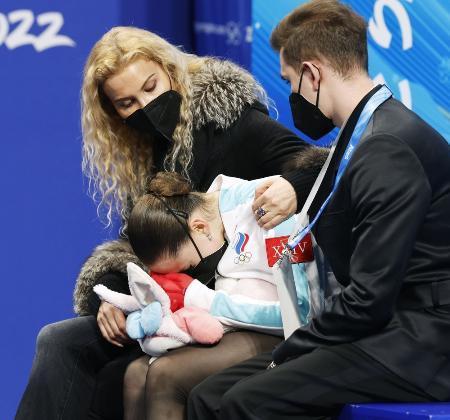 　フィギュアスケート女子フリーの演技後、得点を確認し泣き崩れるカミラ・ワリエワ（中央）。左はエテリ・トゥトベリゼ・コーチ＝１７日、北京（共同）