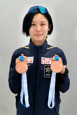 　成田空港で世界選手権の銅メダルを手に記念撮影に応じる高木美帆＝１２日
