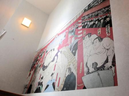 　安治川部屋の階段の壁に飾られた相撲の錦絵