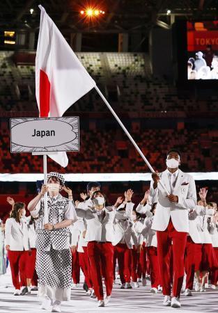 　東京五輪の開会式で、日本選手団の旗手を務める八村塁（手前右）と須崎優衣（同左）＝２０２１年７月、国立競技場
