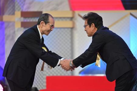 　プレゼンターの王貞治ソフトバンク球団会長（左）と握手する栗山英樹前侍ジャパン監督（撮影・西岡正）