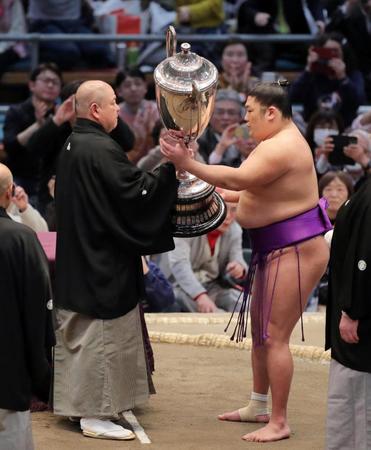 　初優勝を果たし、賜杯を受け取る尊富士（右）