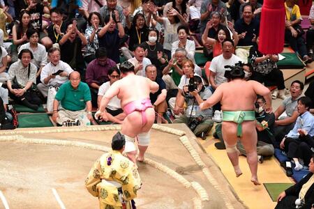 　琴桜（右）を押し出しで破った宇良。館内に拍手と大歓声が響き渡る（撮影・開出牧）