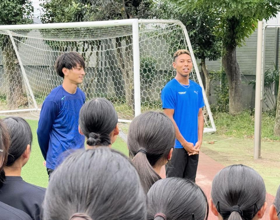 　母校の八王子高を訪問した橋岡優輝（左）がサプライズで呼んだサニブラウンが登場し、驚きの声を挙げる陸上部員たち