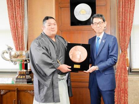 　後藤健二理事長から優勝レリーフを贈られる尊富士
