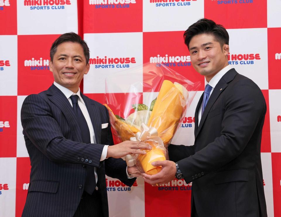 　野村忠宏氏（左）から花束を手渡される丸山城志郎