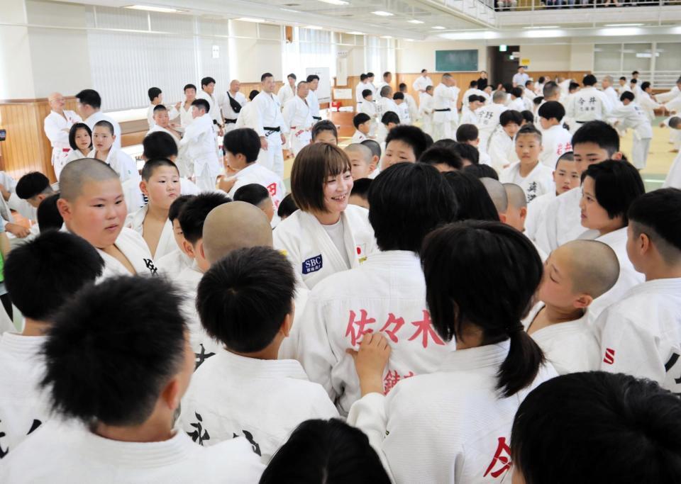 　指導中に小学生に囲まれてもみくちゃになる角田