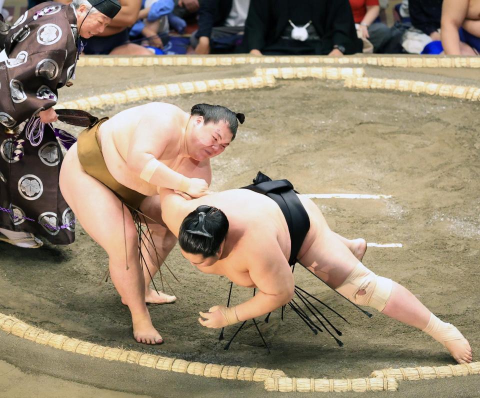 　王鵬（左）が肩透かしで琴桜を破る