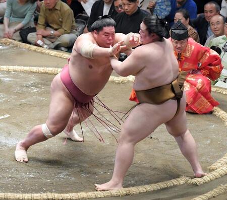　突き出しで王鵬（右）を破り全勝を守った大栄翔（撮影・佐藤厚）