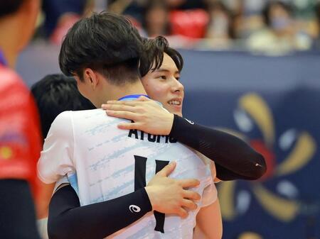 　鳥飼亜斗夢（手前）と抱き合うサントリー・高橋藍（撮影・石湯恒介）