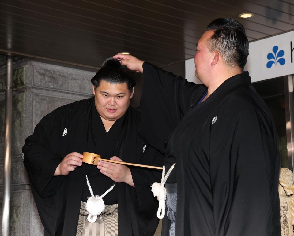 　二所ノ関親方（右）にまげを整えてもらう大の里（撮影・佐々木彰尚）