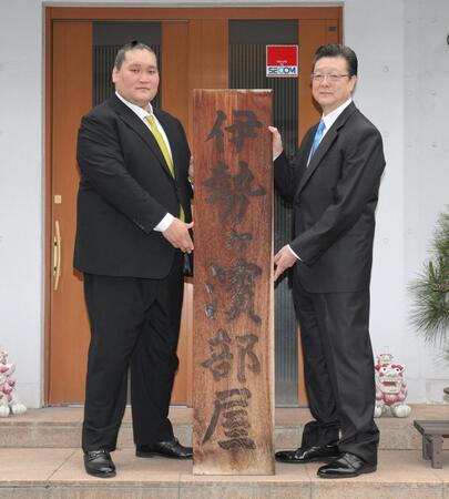 　伊勢ケ浜部屋の看板を持つ伊勢ケ浜親方（左）と宮城野親方（撮影・西岡正）
