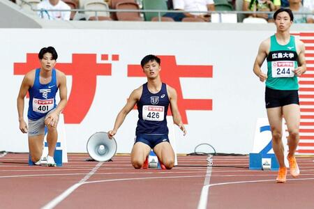 　男子１００メートル予選　不正スタートで失格となった柳田大輝（中央）