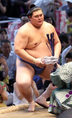 　高安を下し懸賞金の袋を両手で持つ大の里