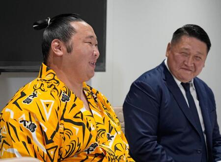 　新十両昇進を決め、大島親方（右）と記者会見する旭海雄