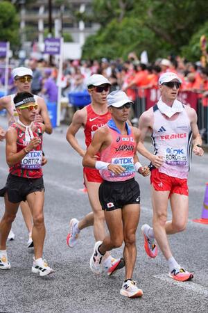 　懸命に歩く山西利和（右から２人目）