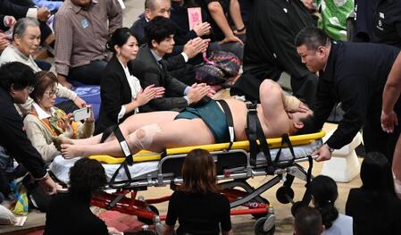 　輝戦で負傷し、担架で運ばれる三田