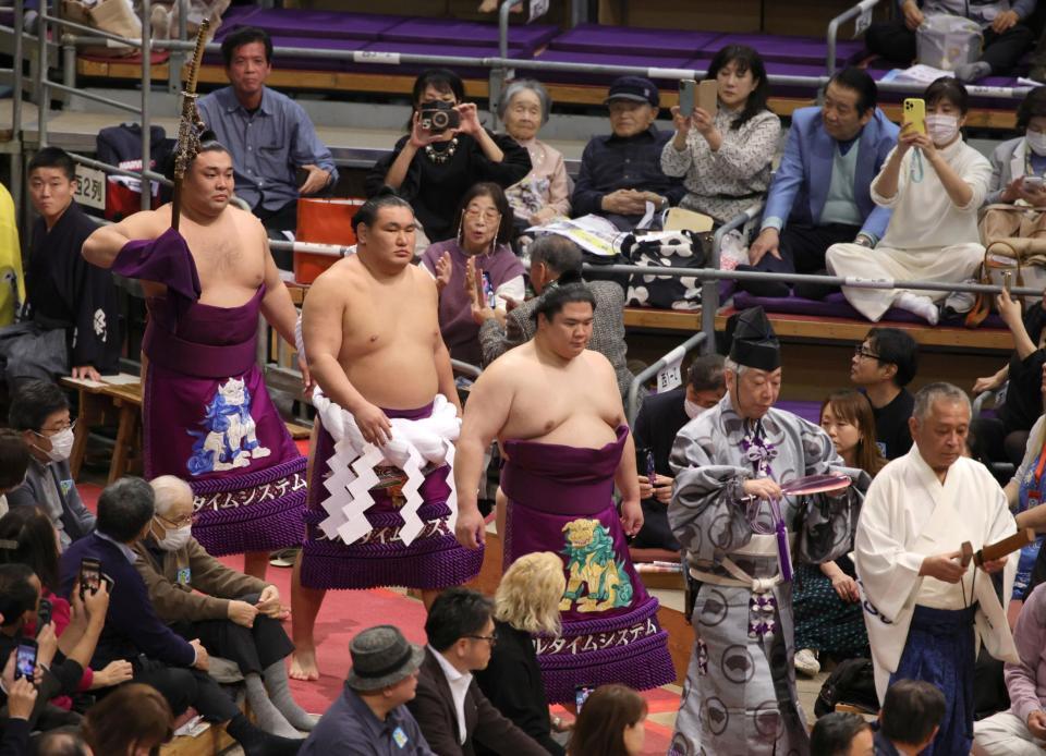 　豊昇龍（中央）の土俵入りで太刀持ちを務めた霧島（左。露払いは宇良）＝撮影・坂部計介