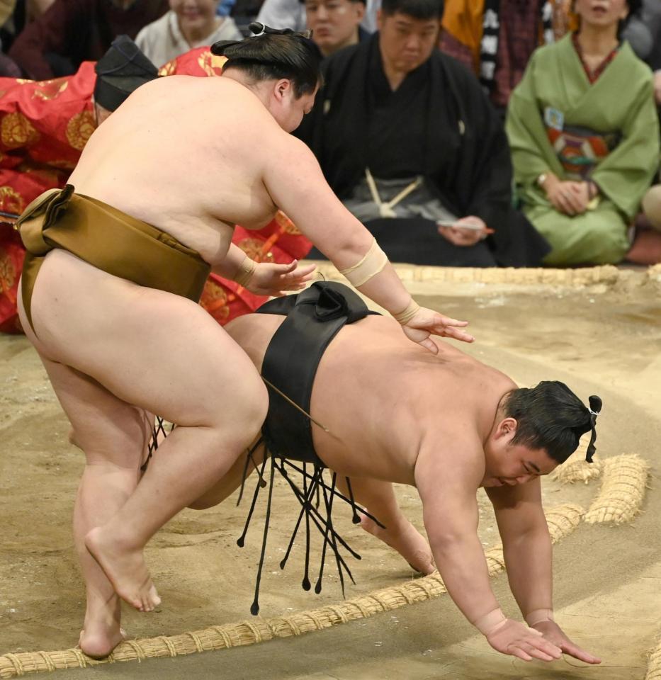 　王鵬（左）がはたき込みで伯桜鵬を下す