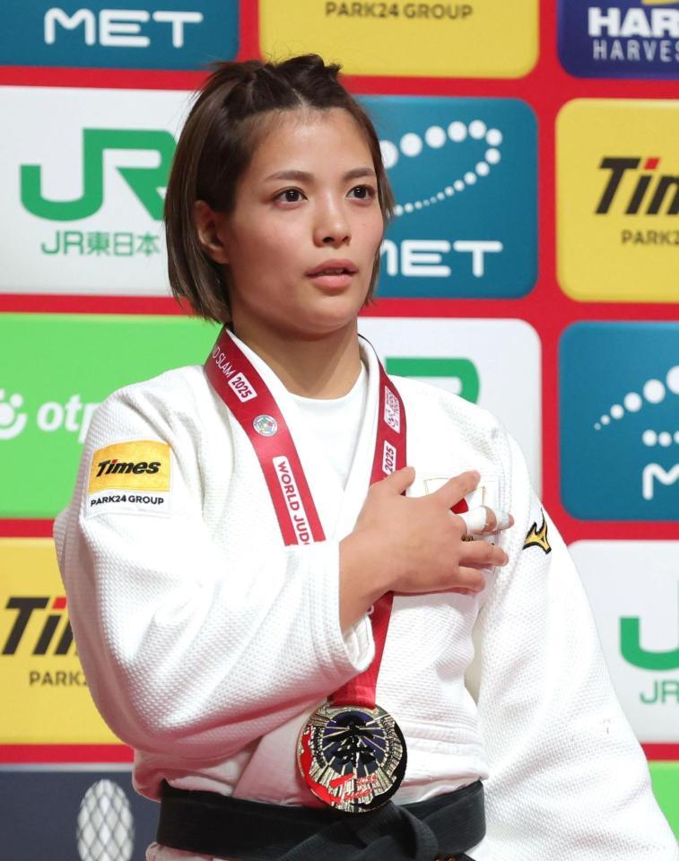 　表彰台で胸に手を当てて君が代を歌う阿部詩（撮影・西岡正）