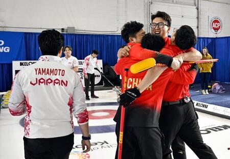 　男子プレーオフで日本を破って五輪出場権を獲得し、歓喜する中国選手（右）＝共同