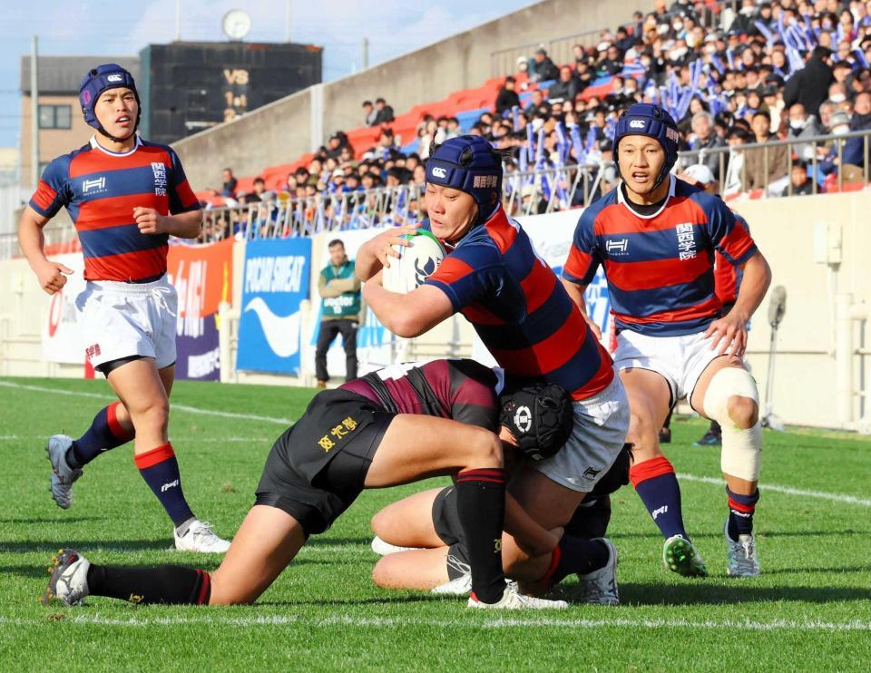 　前半、関西学院・黒田がタックルを受けながらも先制トライを決める（撮影・山口登）