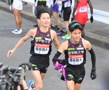 　区間新の快走で２区・上原（右）にタスキをつなぐ国学院大・青木（撮影・伊藤笙子）