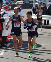 　たすきをつなぐ東洋大・網本佳悟（左）と久保田琉月（撮影・金田祐二）