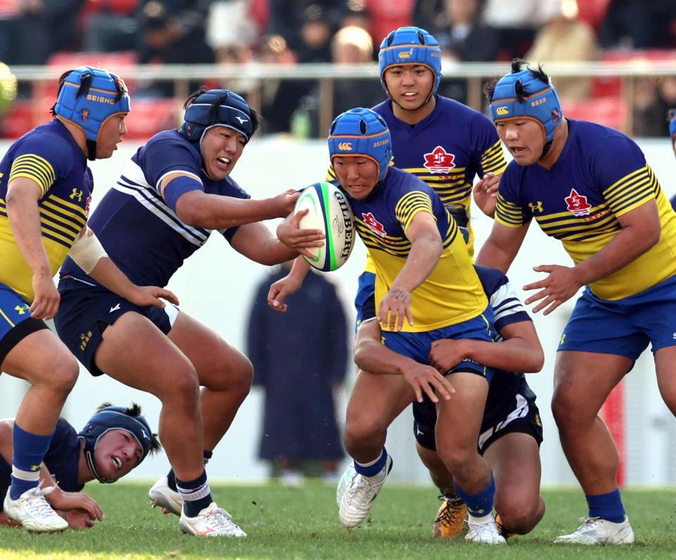 　前半、桐蔭学園・堂薗尚悟（左から２人目）は京都成章・岡元聡志（中央）の突進を阻む（撮影・山口登）