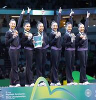 　新体操の世界選手権団体総合の表彰式で、金メダルを手にする日本代表の選手たち＝２５年８月（共同）