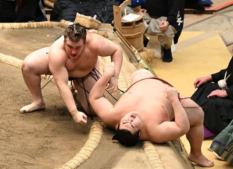 優勝決定戦で、安青錦（左）は首投げで熱海富士（右）を破る