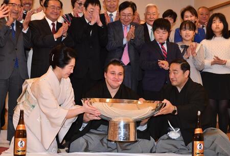 　祝勝会で大杯を手に笑顔の安青錦（中央）。右は安治川親方、左は女将の杉野森絵莉さん（撮影・開出牧）