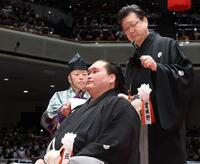 師匠だった宮城野正也さん（右）に止めばさみを入れられる元照ノ富士の伊勢ケ浜親方