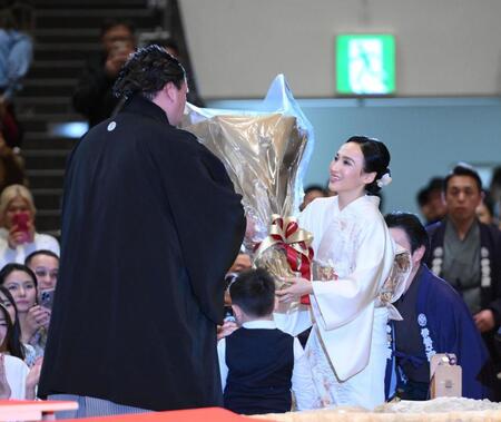 断髪式でドルジハンド夫人（右）から花束を受け取る伊勢ケ浜親方。中央下は長男の照務甚（テムジン）くん＝両国国技館（撮影・開出牧）