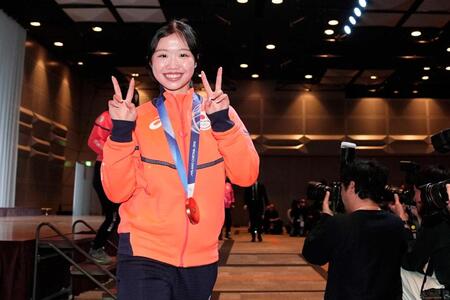 　記者会見を終え、笑顔で引き揚げるフィギュアスケートの中井亜美＝２４日午後、東京都内