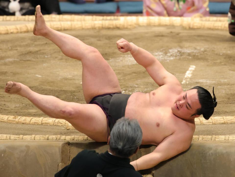 錦木（左）に寄り倒しで敗れ、土俵から落ちる炎鵬（撮影・坂部計介）