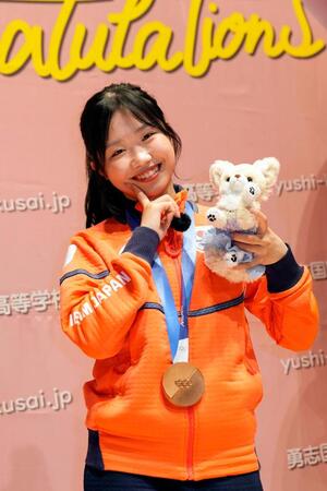 ミラノ・コルティナ冬季五輪で銅メダルを獲得し、勇志国際高が開いた祝賀会で写真撮影に応じるフィギュアスケート女子の中井亜美